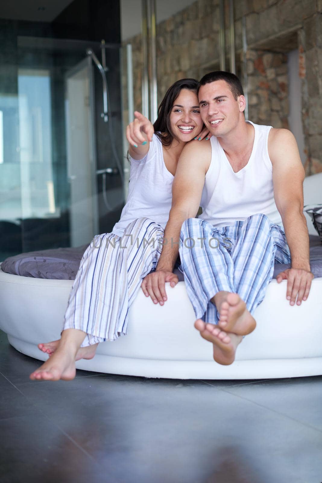 happy young couple relax and have fun in bed