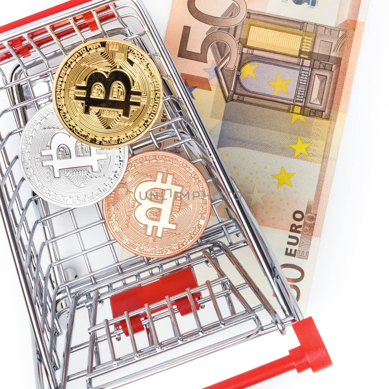 Image of bitcoins in shopping cart on euro bill