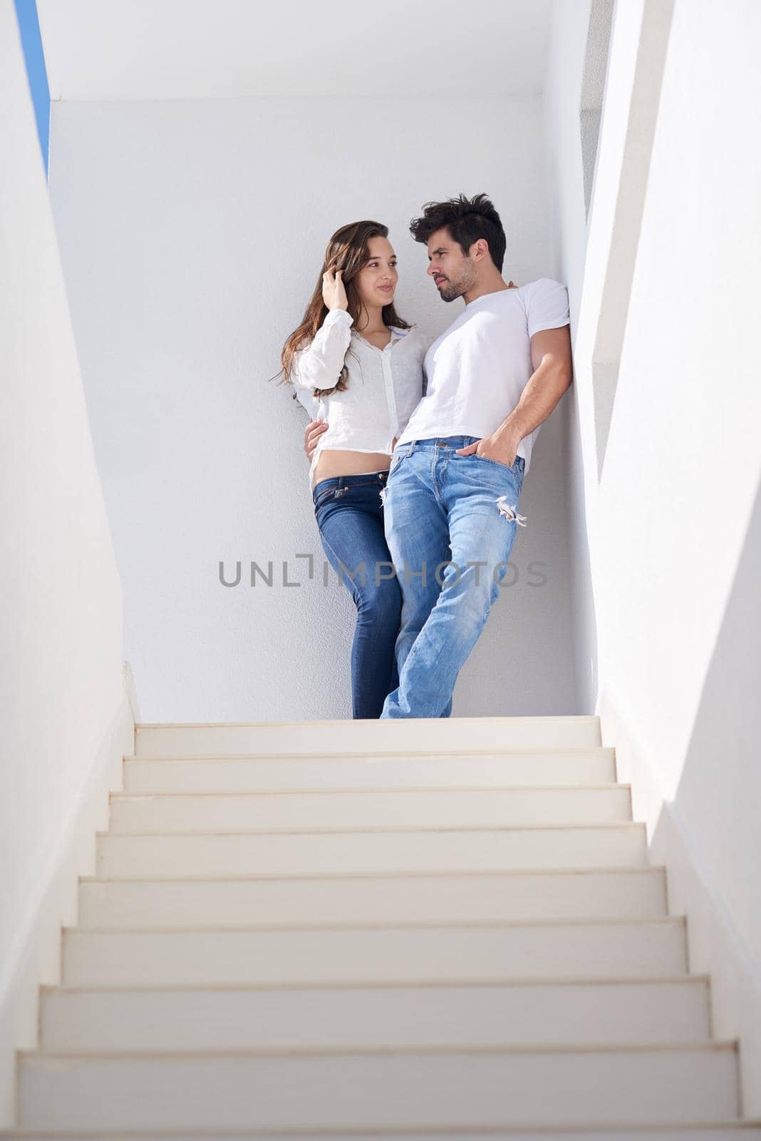 happy young romantic couple have fun relax smile at modern home outdoor terace balcony terace