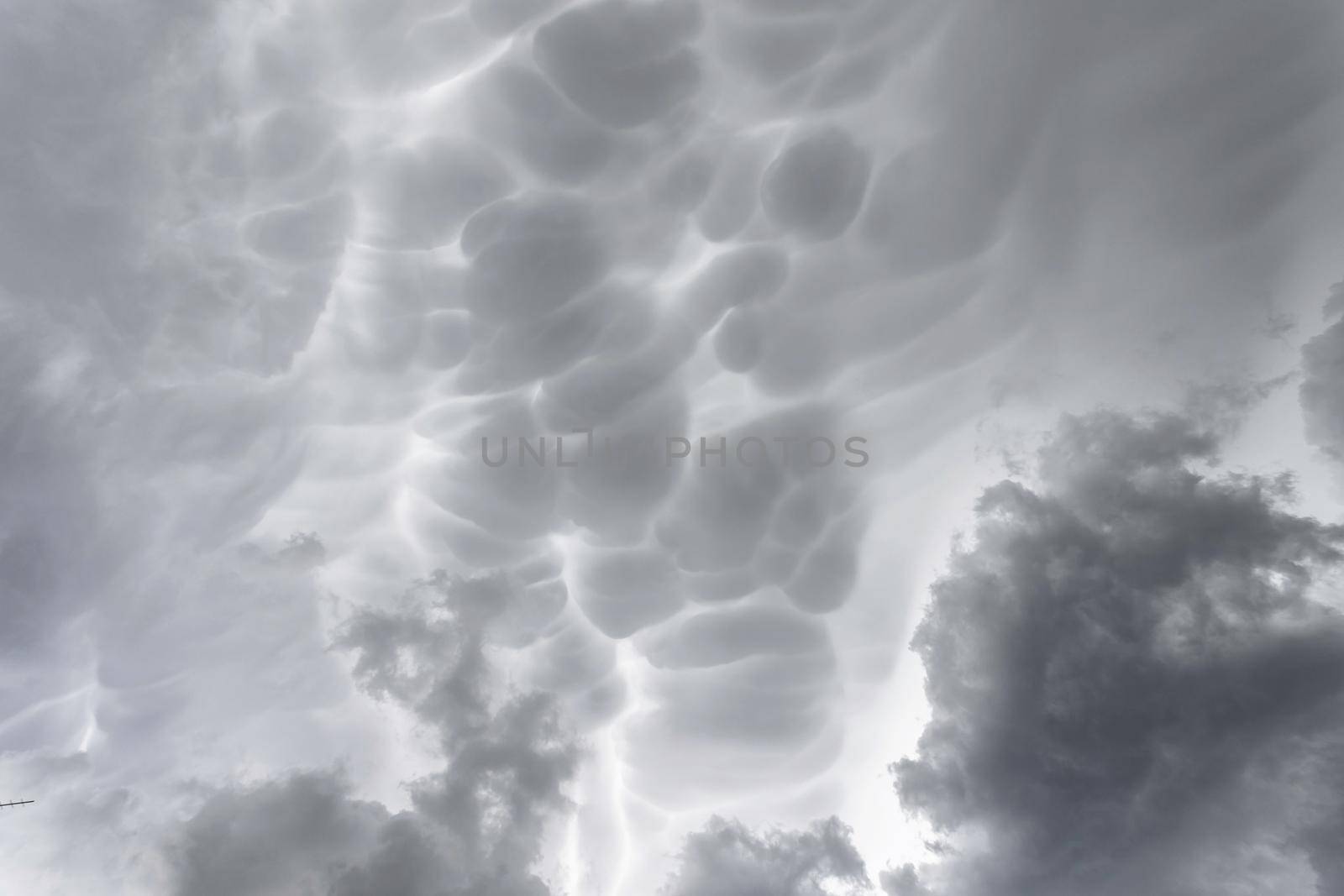 Mammatus storm clouds. Mammatus thunder clouds making an ideal stormy background.