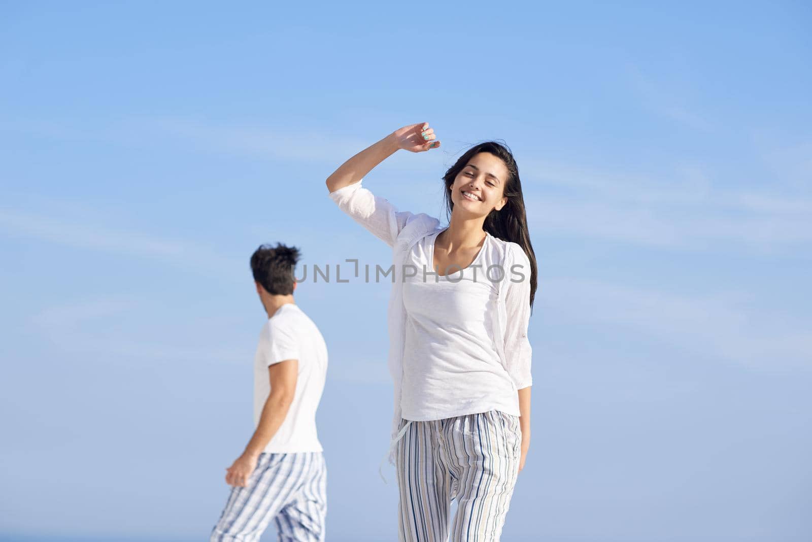 happy young romantic couple have fun relax smile at modern home outdoor terace balcony