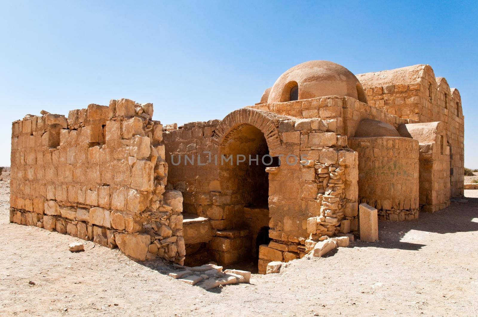 ancient desert ruins in Jordan with blue sky in background