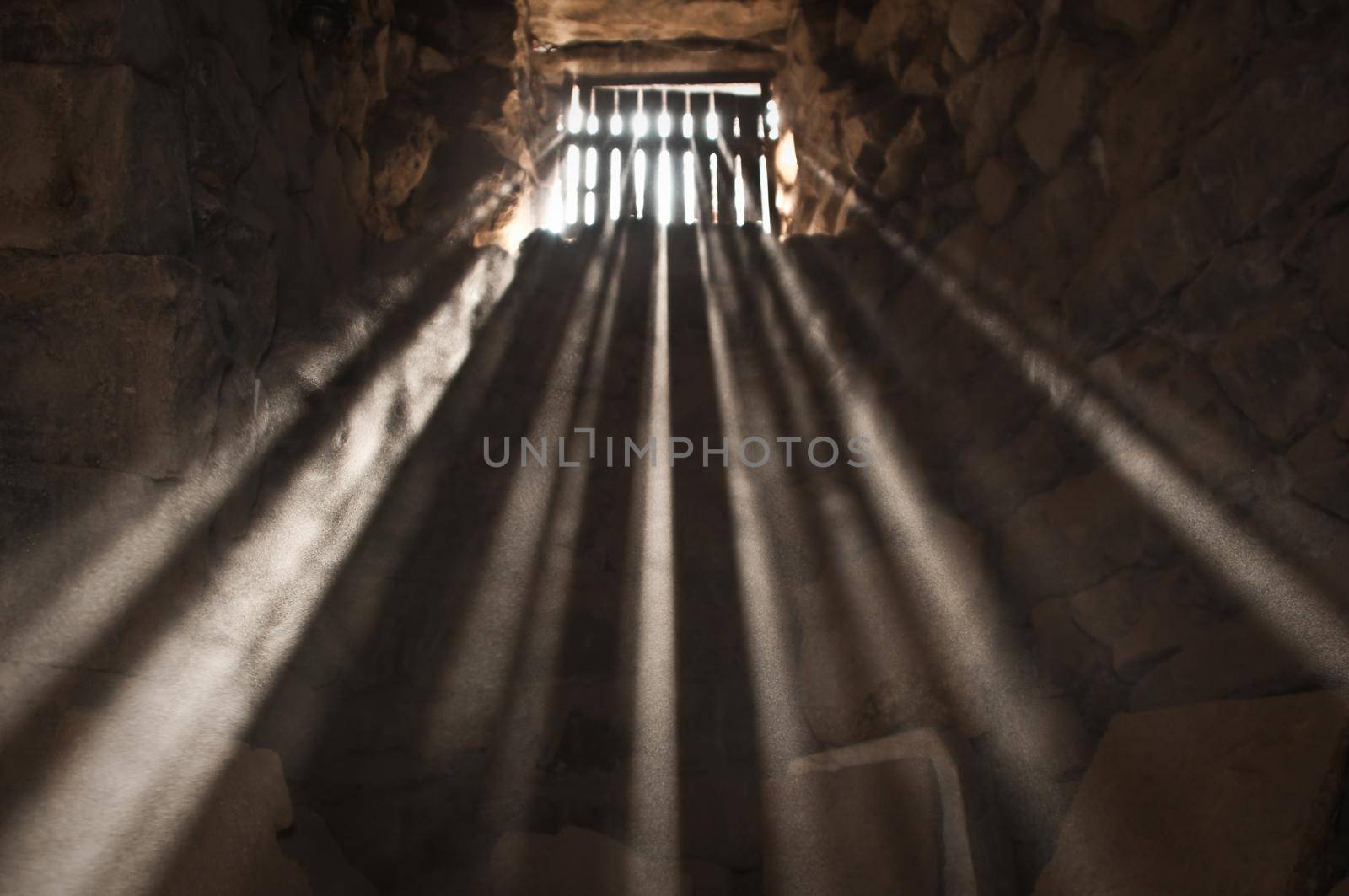 sun rays beaming through the jail window into the cell