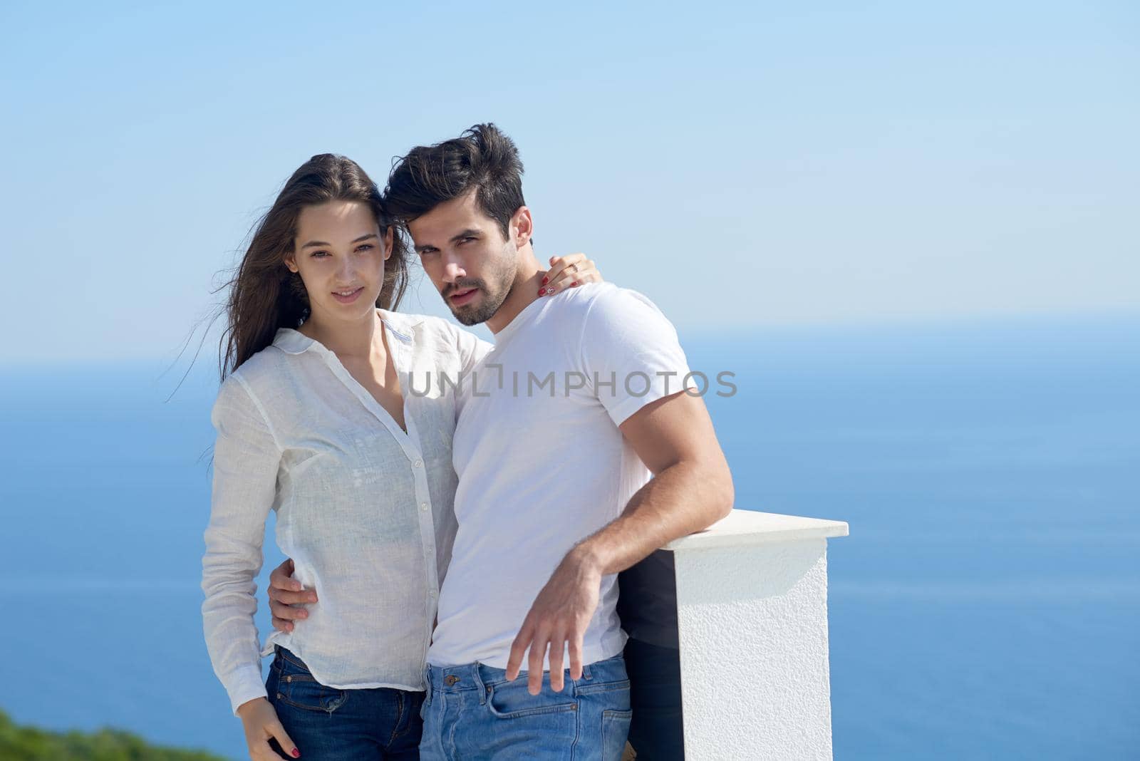 happy young romantic couple have fun relax smile at modern home outdoor terace balcony terace