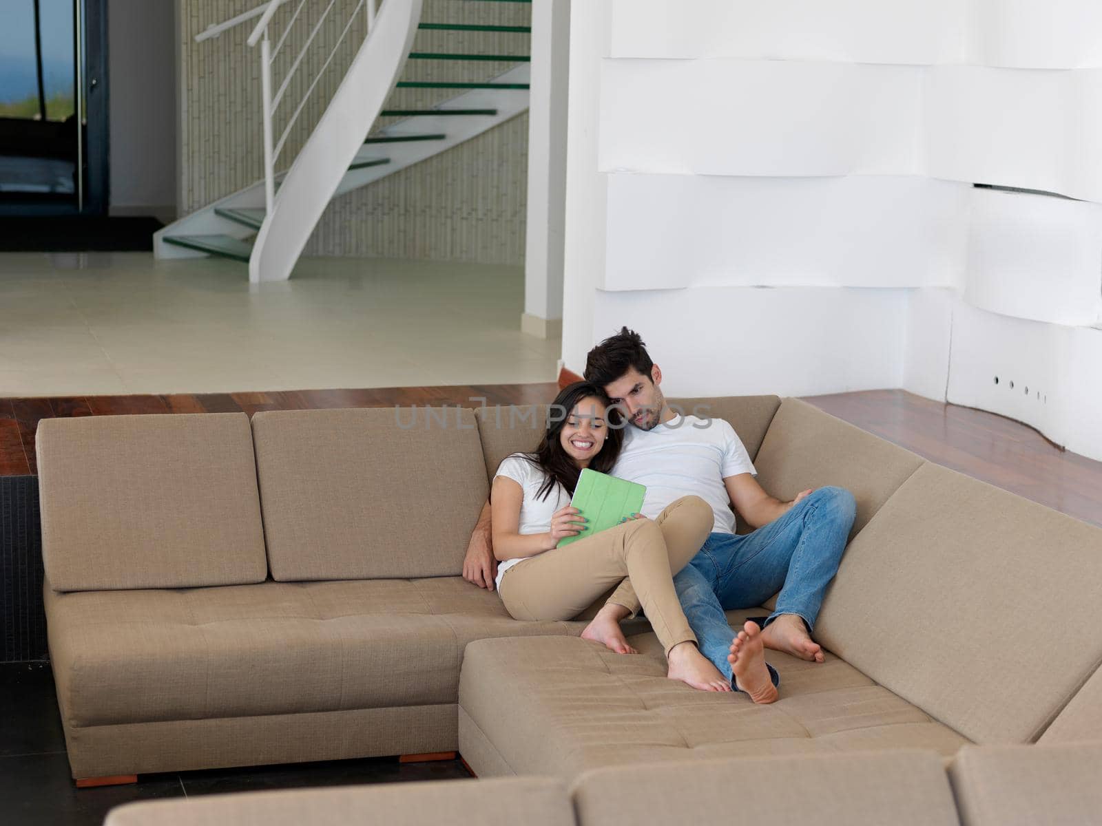 cheerful happy young couple making selfie together at home