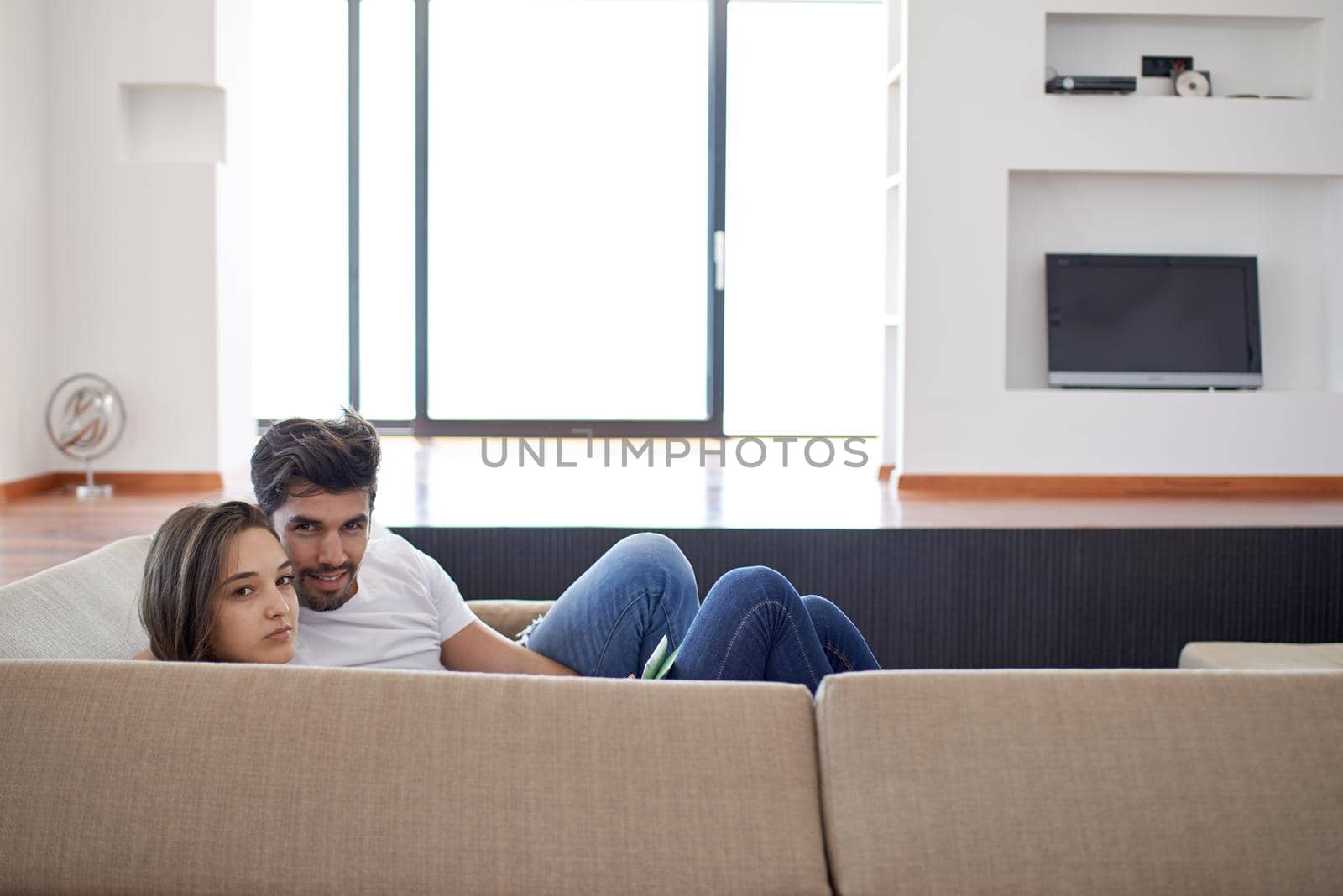 romantic happy young couple relax at modern home staircase indoors