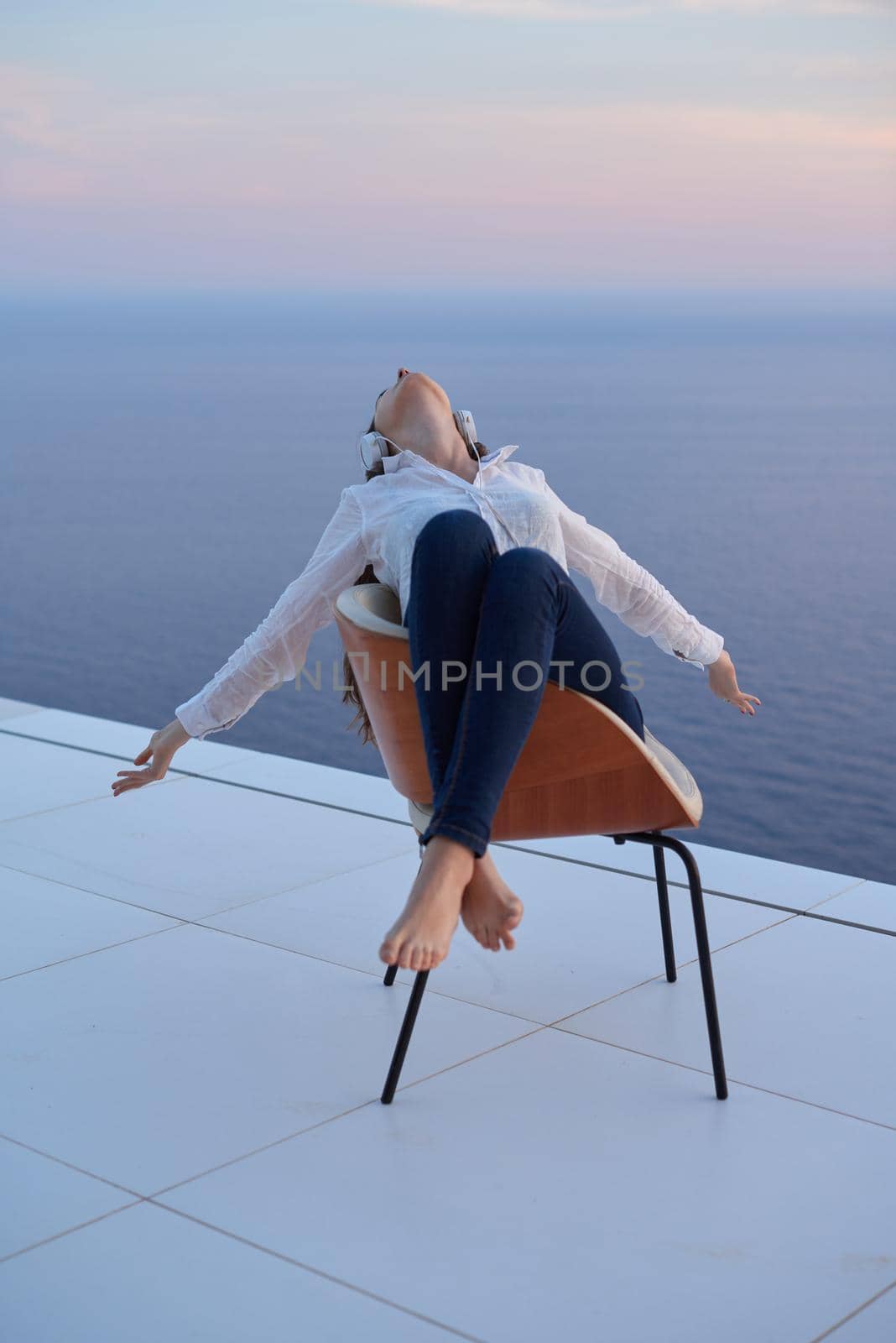 happy young woman enjoy sunset while dancing and enjoy music on headphones