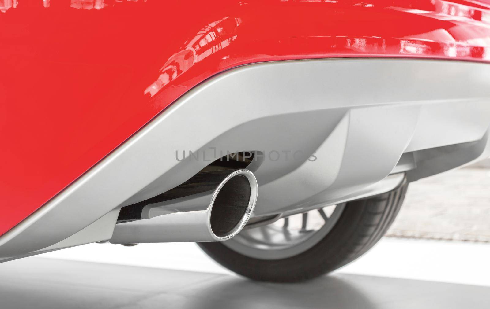 New exhaust of a sports car. Ecology concept, low emission, low environmental impact.