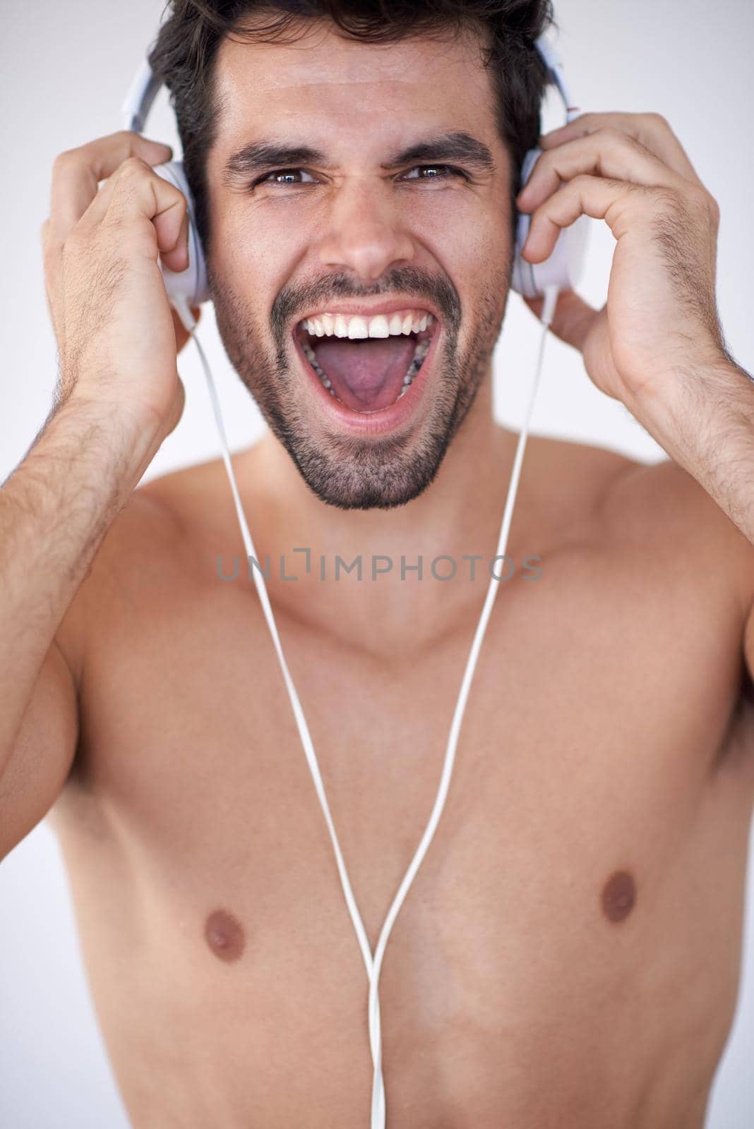 handsome young man listening music on headphones by dotshock