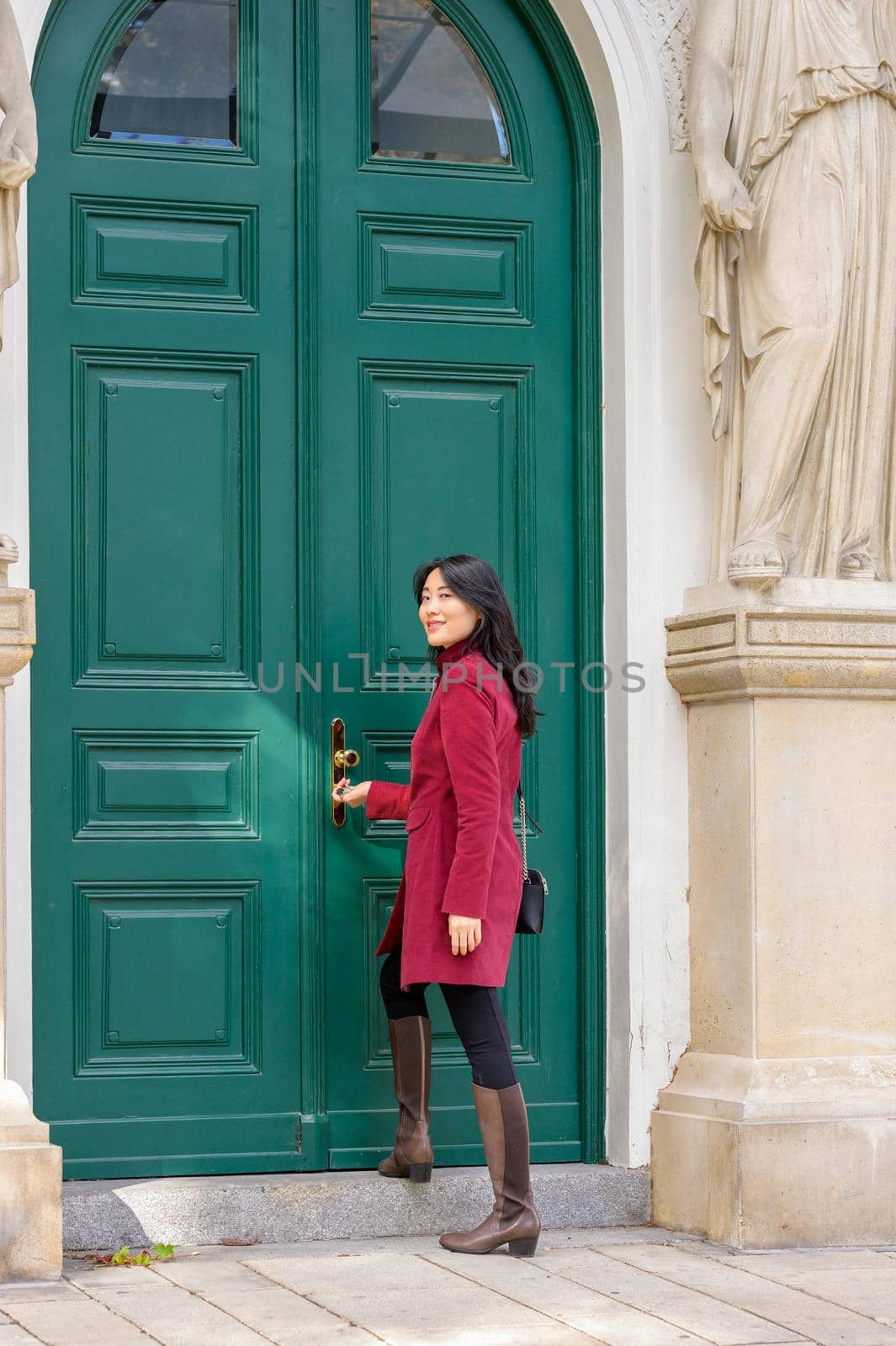 Beautiful chinese woman with long black hair on a sunny autumn day in the city.
