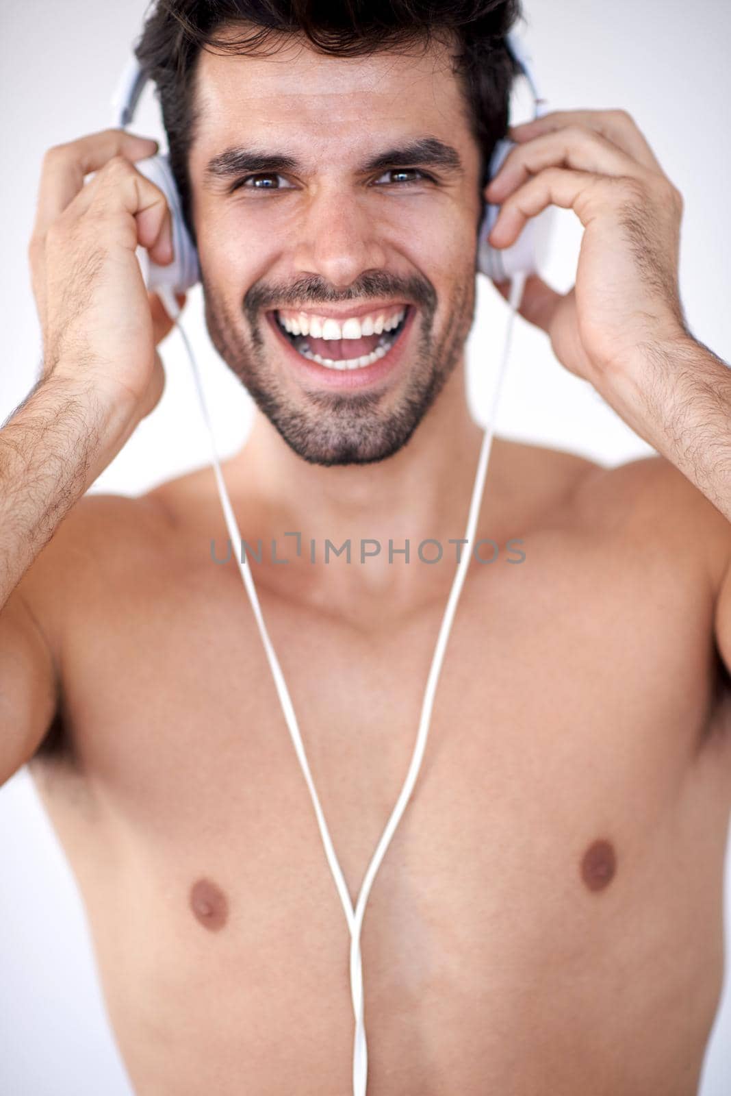 handsome young man listening music on headphones by dotshock