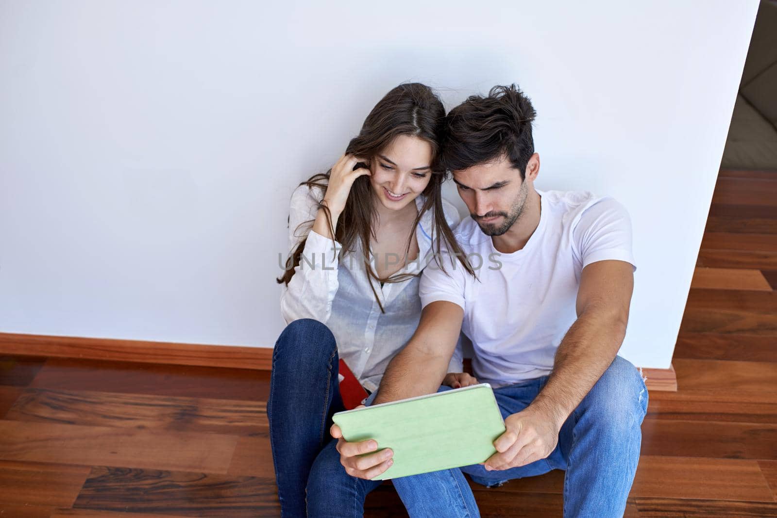 romantic relaxed young couple at modern home using tablet computer