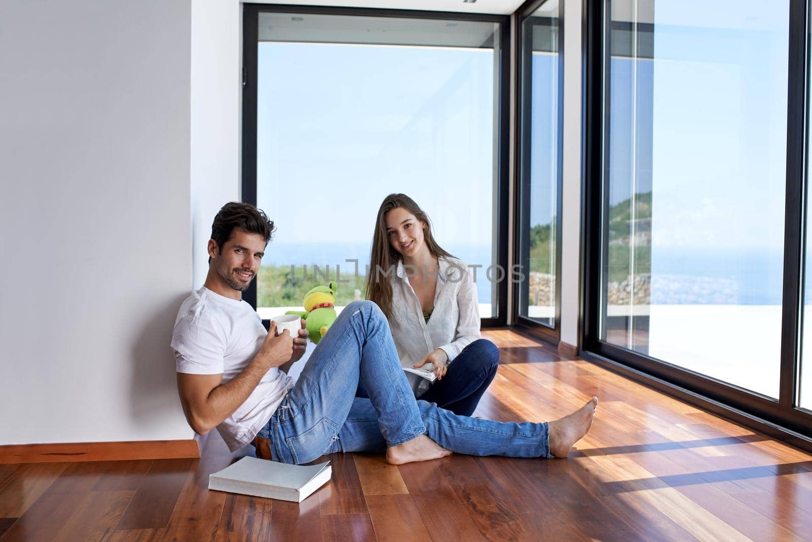 romantic happy young couple relax at modern home staircase indoors