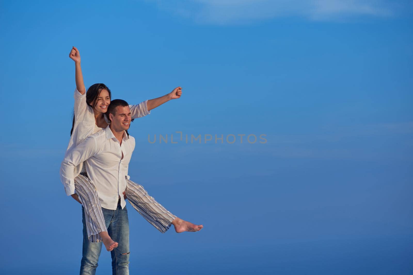 happy young romantic couple have fun relax smile at modern home outdoor terace balcony terace