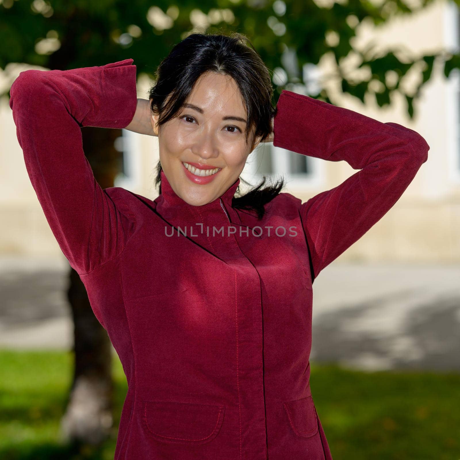 Beautiful chinese woman with long black hair on a sunny autumn day in the city,