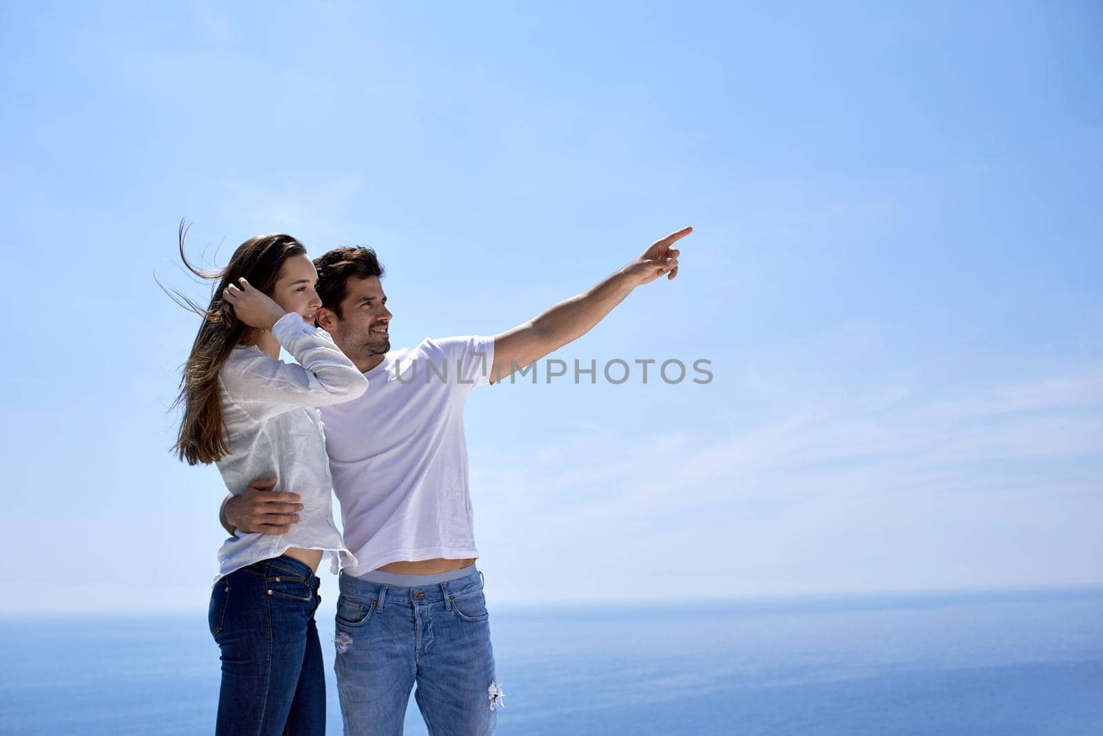 happy young romantic couple have fun relax smile at modern home outdoor terace balcony