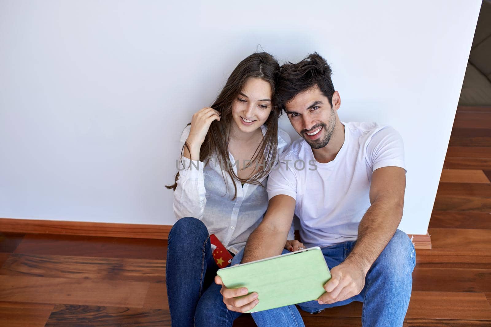 romantic relaxed young couple at modern home using tablet computer