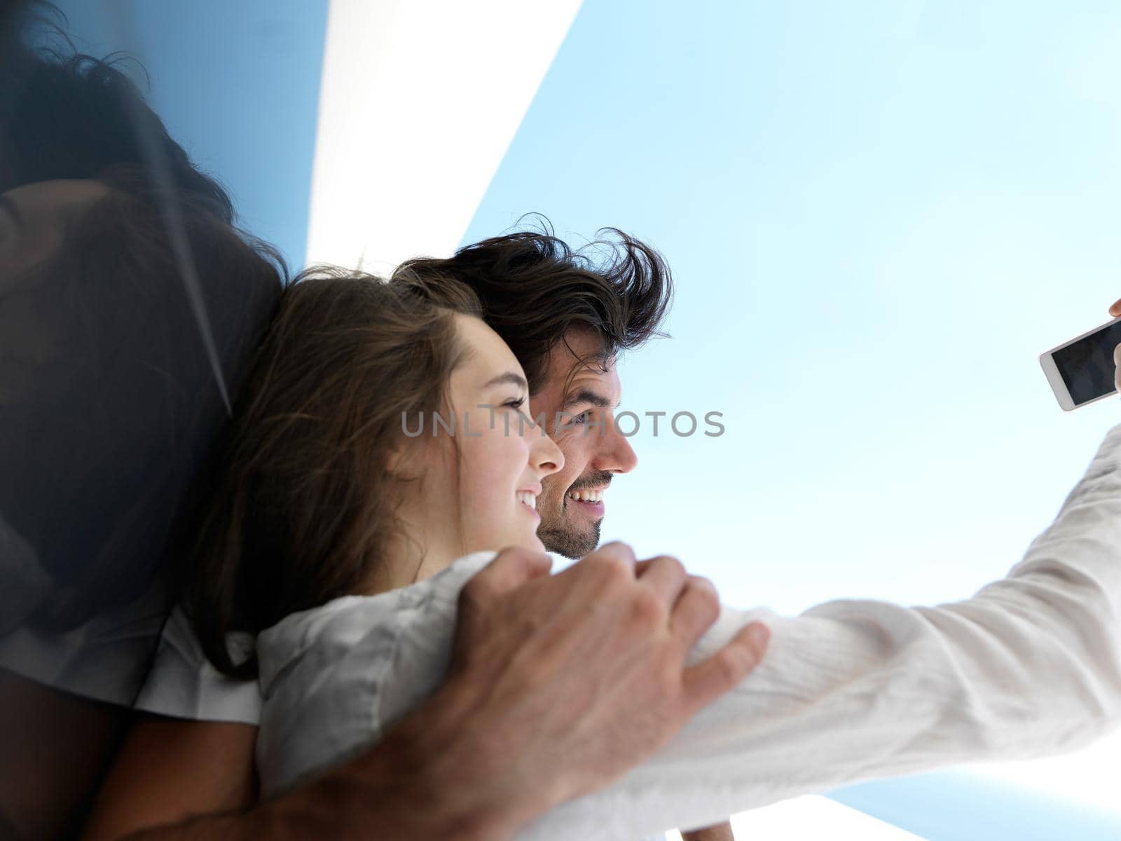 young couple making selfie together at home by dotshock