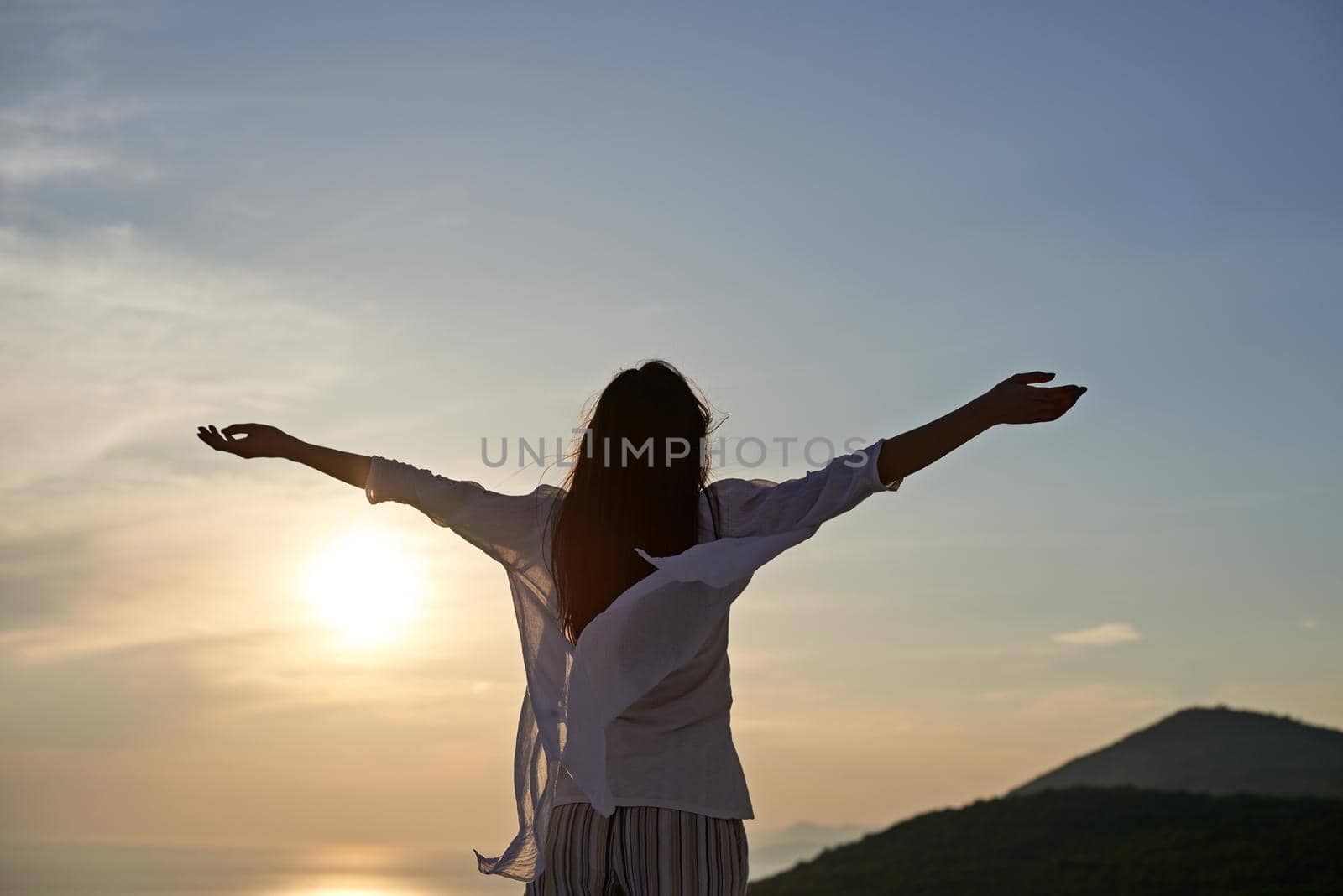 happy young woman enjoy sunset while dancing and enjoy music on headphones