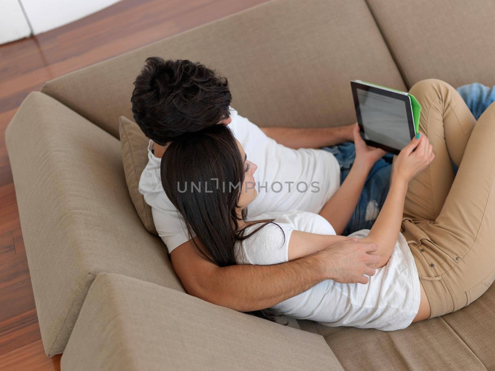 cheerful happy young couple making selfie together at home