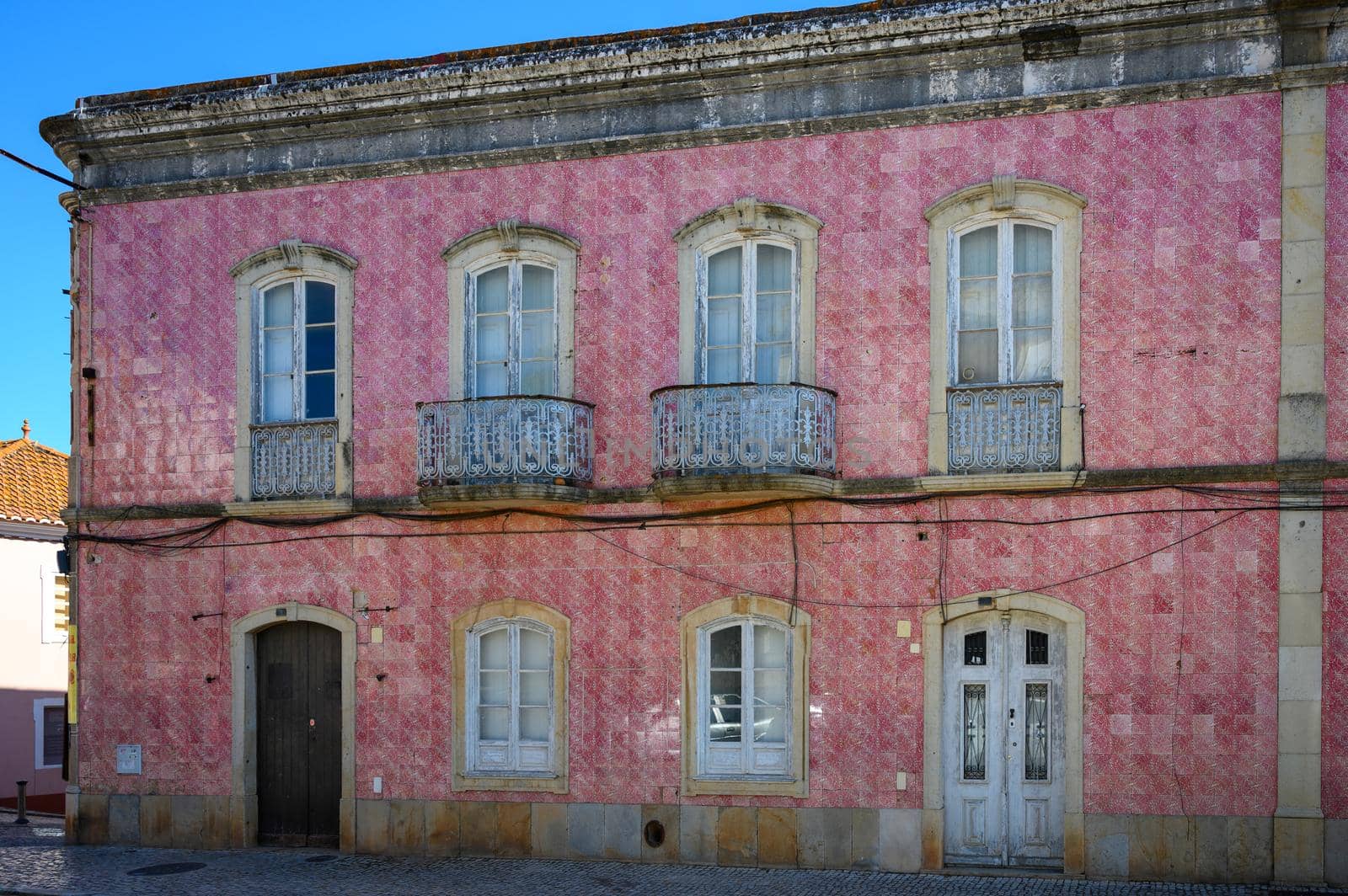 An old red-tiled house in a small Portuguese town.