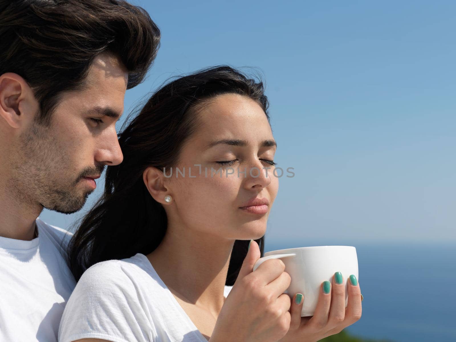 happy young romantic couple have fun relax smile at modern home outdoor terace balcony terace