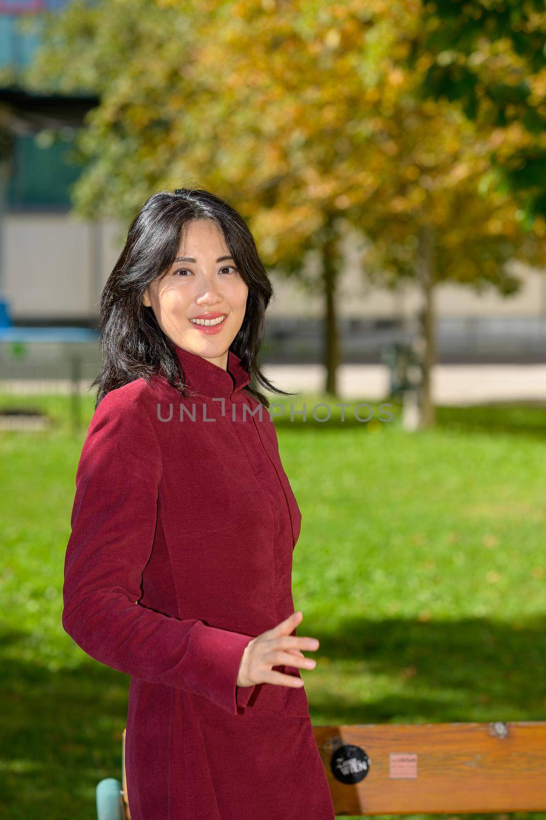 Beautiful chinese woman with long black hair on a sunny autumn day in the city,