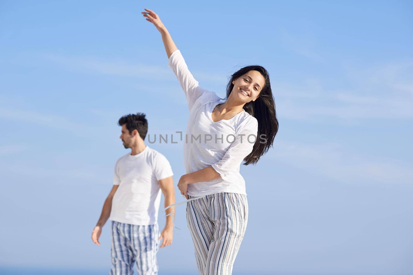 happy young romantic couple have fun relax smile at modern home outdoor terace balcony