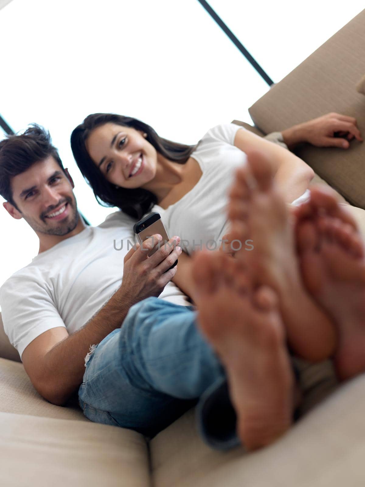 cheerful happy young couple making selfie together at home