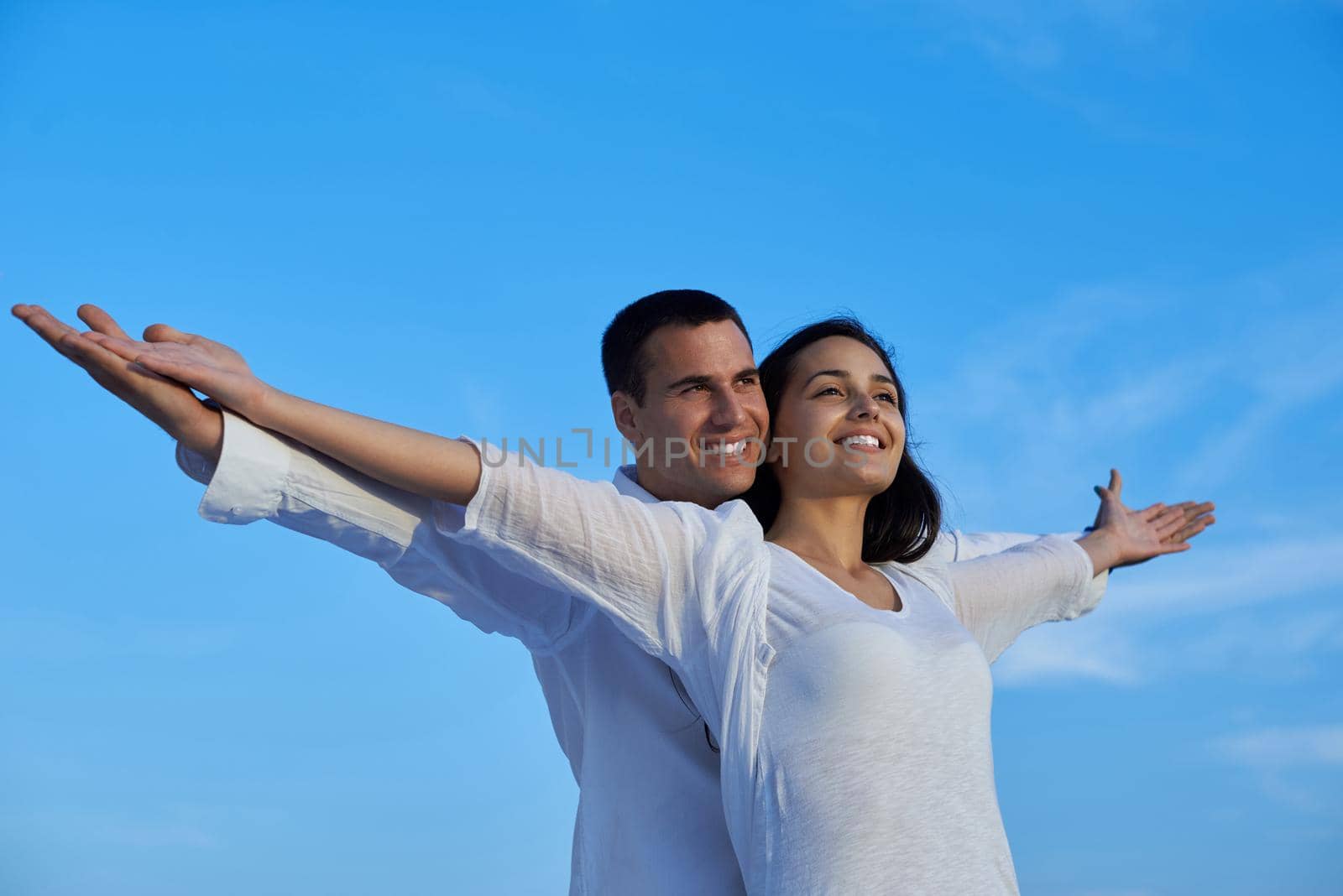 happy young romantic couple have fun relax smile at modern home outdoor terace balcony