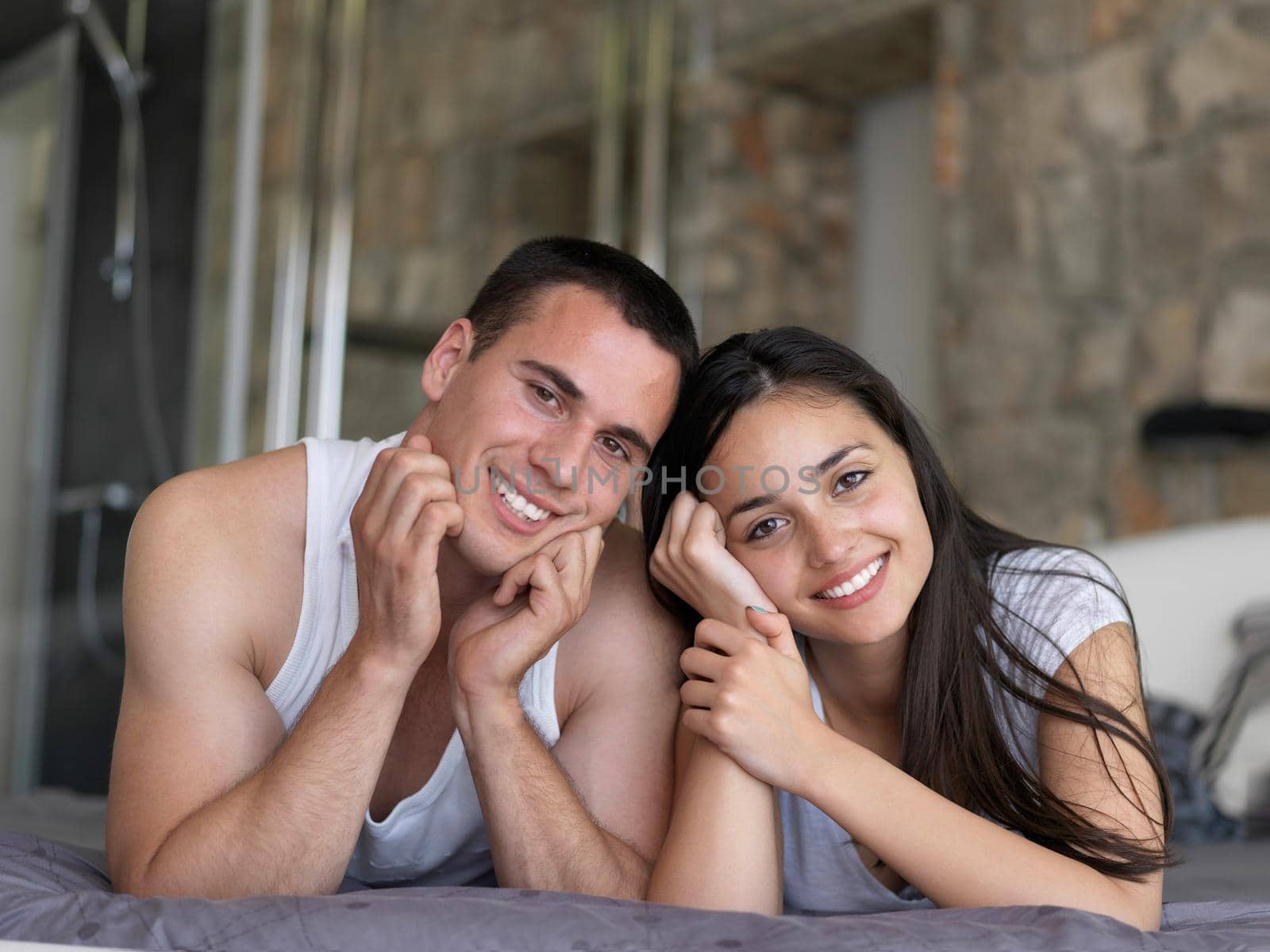 happy young couple relax and have fun in bed