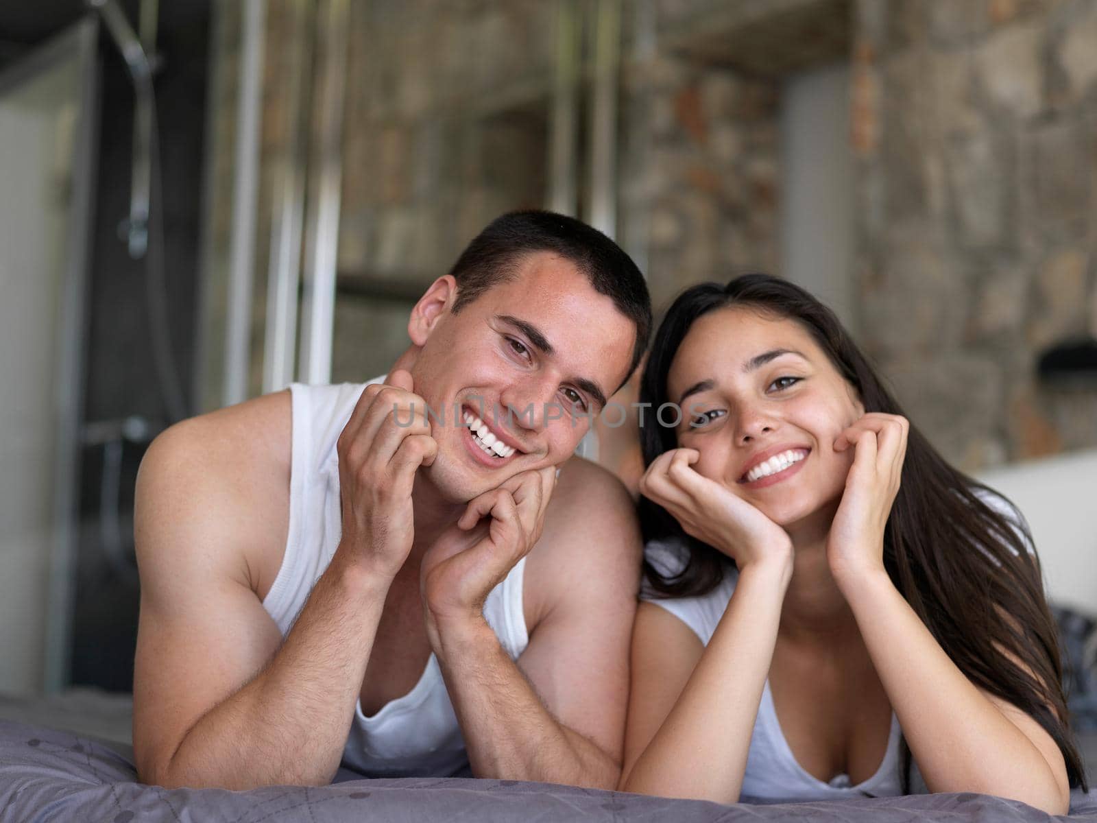 happy young couple relax and have fun in bed