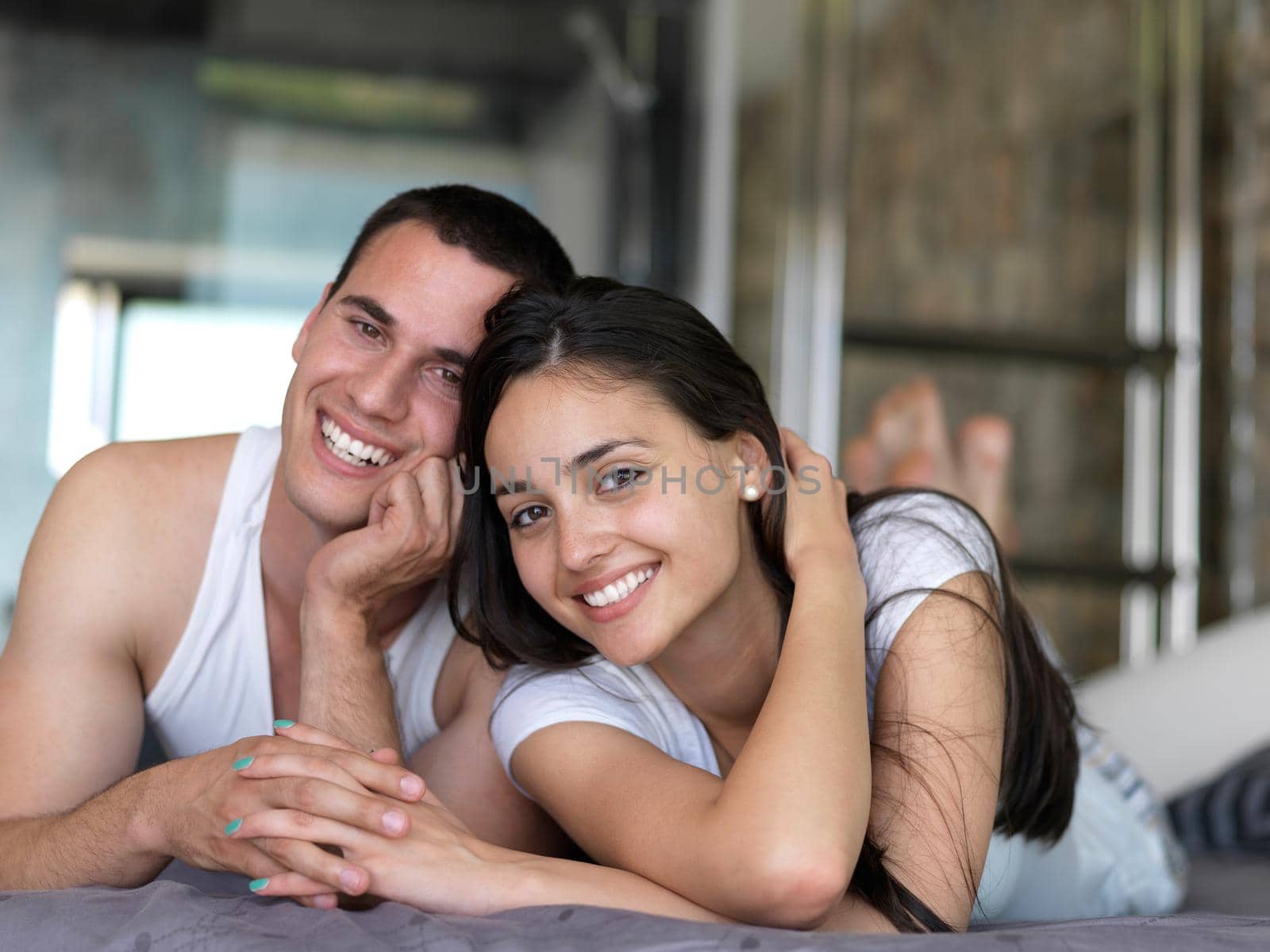 happy young couple relax and have fun in bed