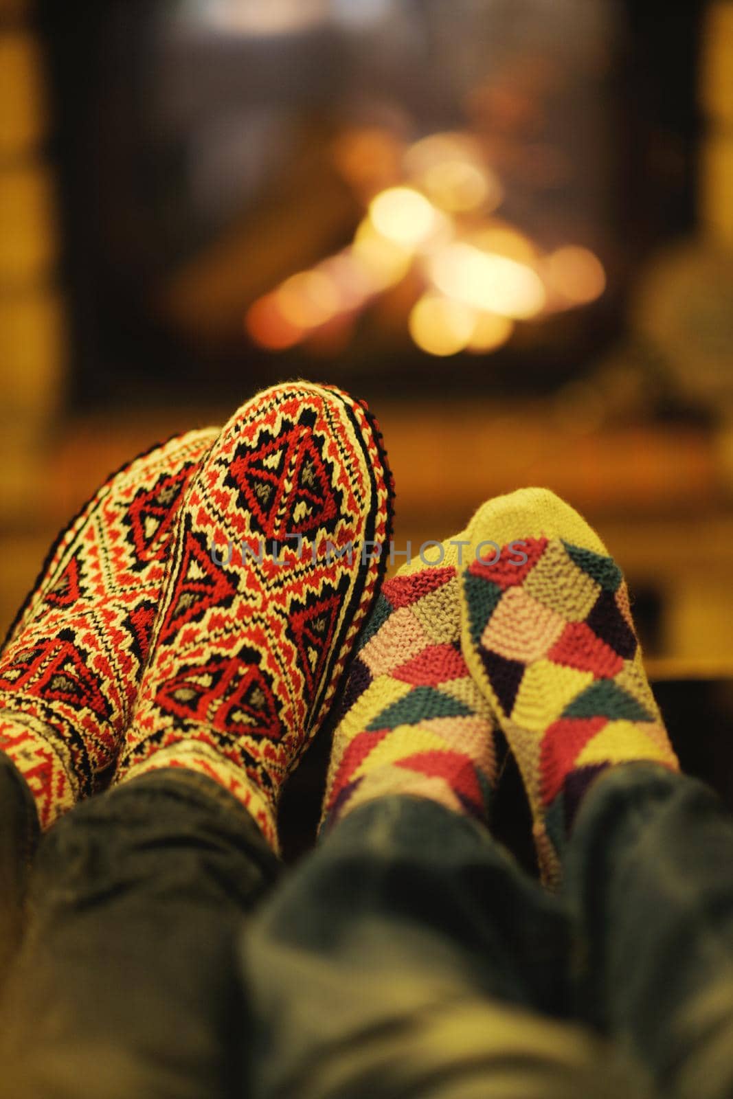 happy Young romantic couple and relaxing sofa in front of fireplace at winter season in home