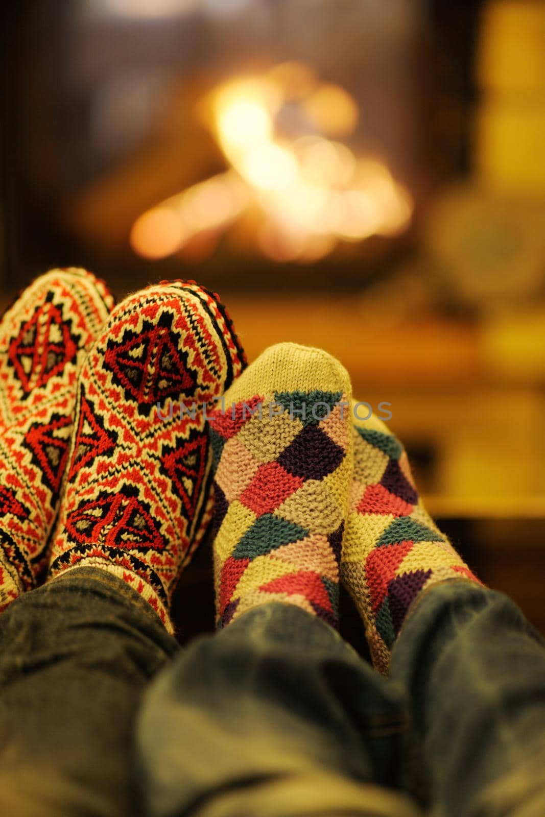 happy Young romantic couple and relaxing sofa in front of fireplace at winter season in home