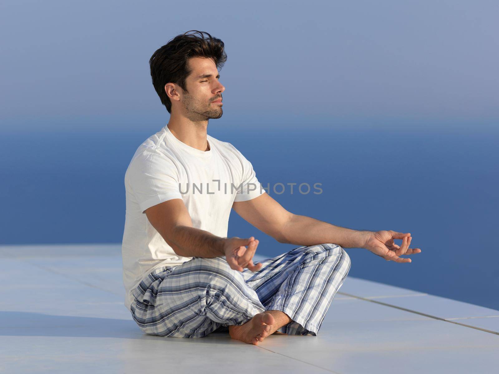 young man practicing yoga by dotshock
