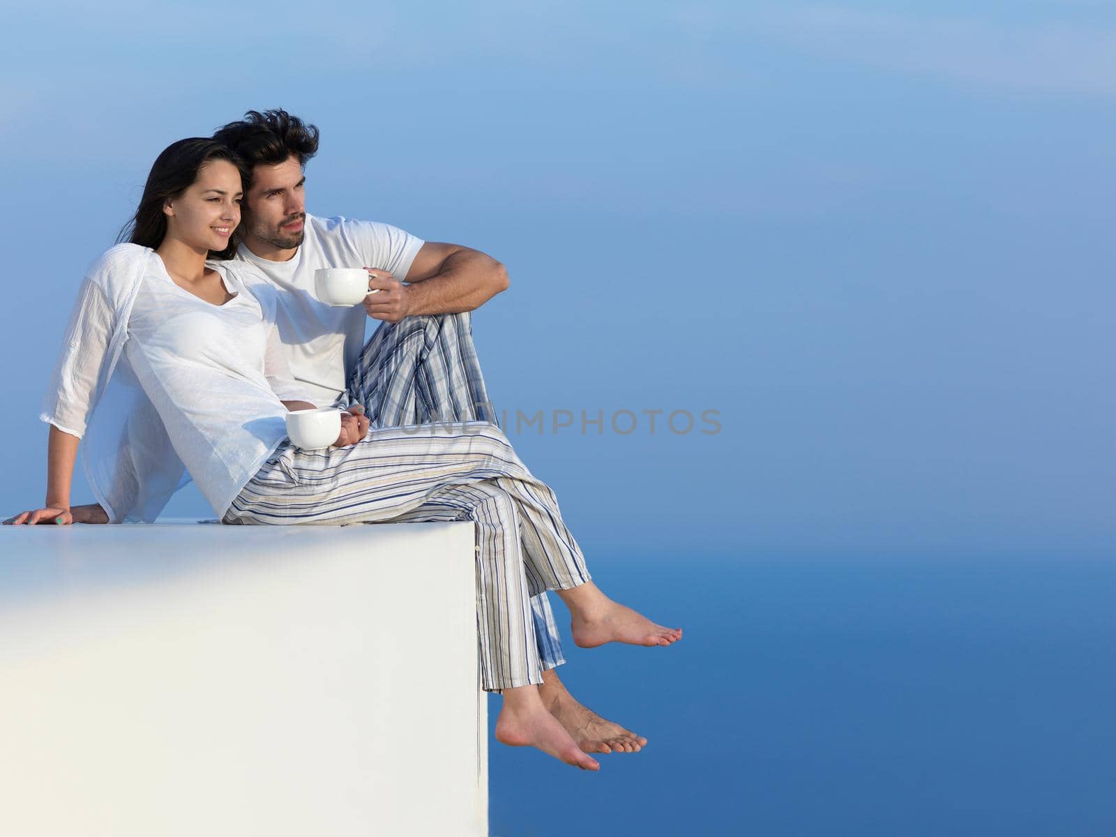 happy young romantic couple have fun relax smile at modern home outdoor terace balcony terace