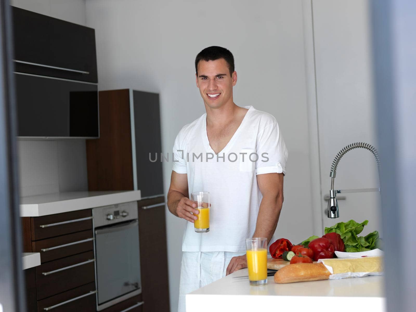 man cooking at home preparing salad in kitchen by dotshock