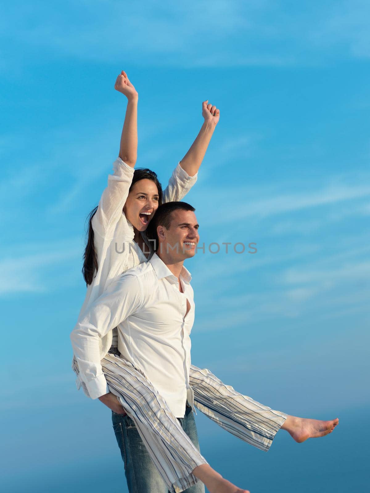 happy young romantic couple have fun relax smile at modern home outdoor terace balcony terace