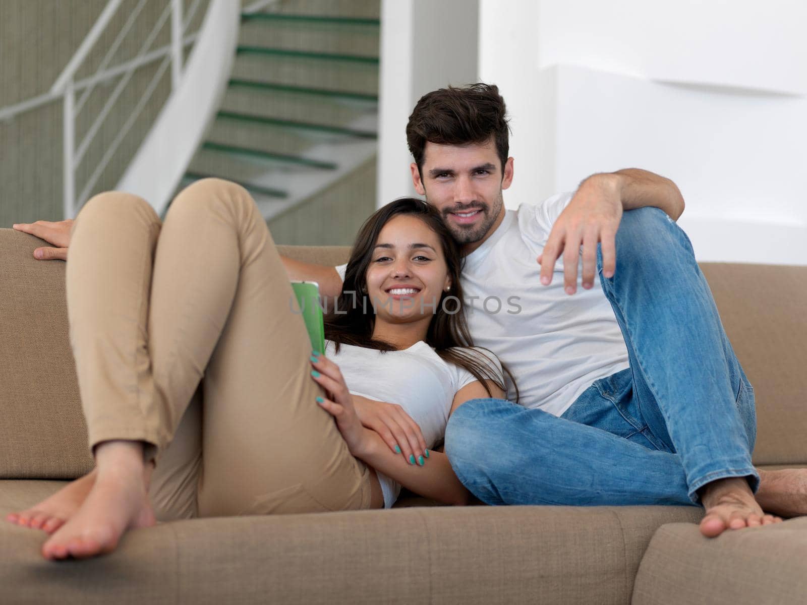 cheerful happy young couple making selfie together at home