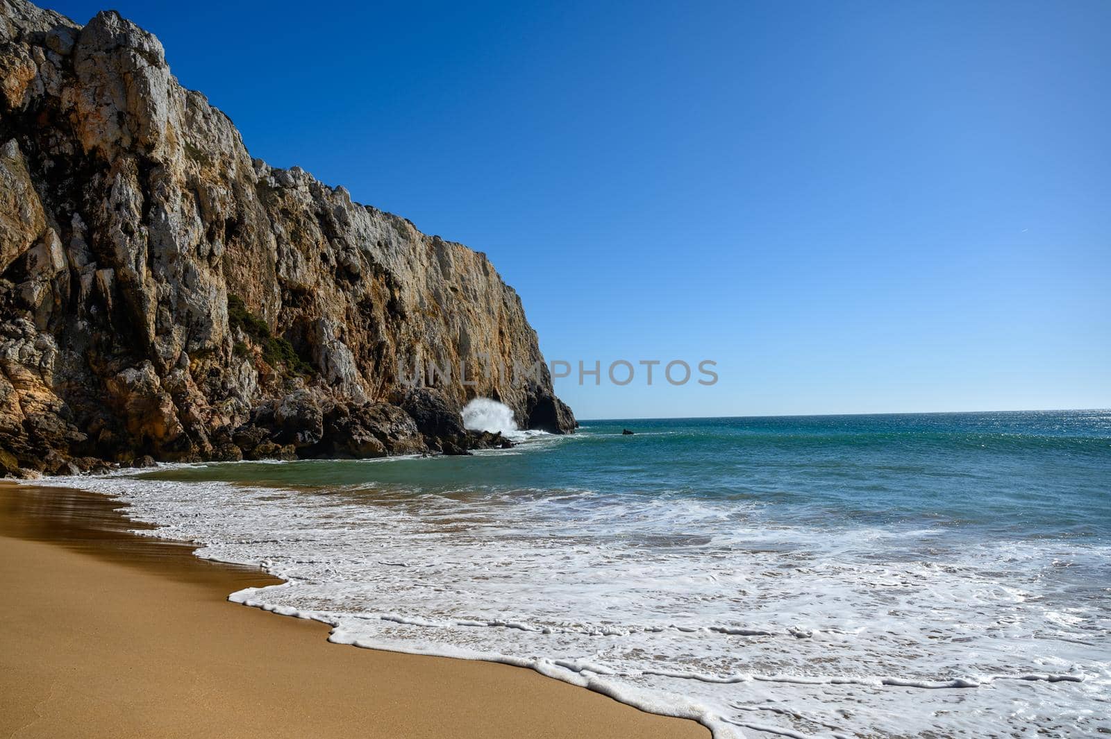 A sandy beach at the Algarve in Portugal with some powerful waves.