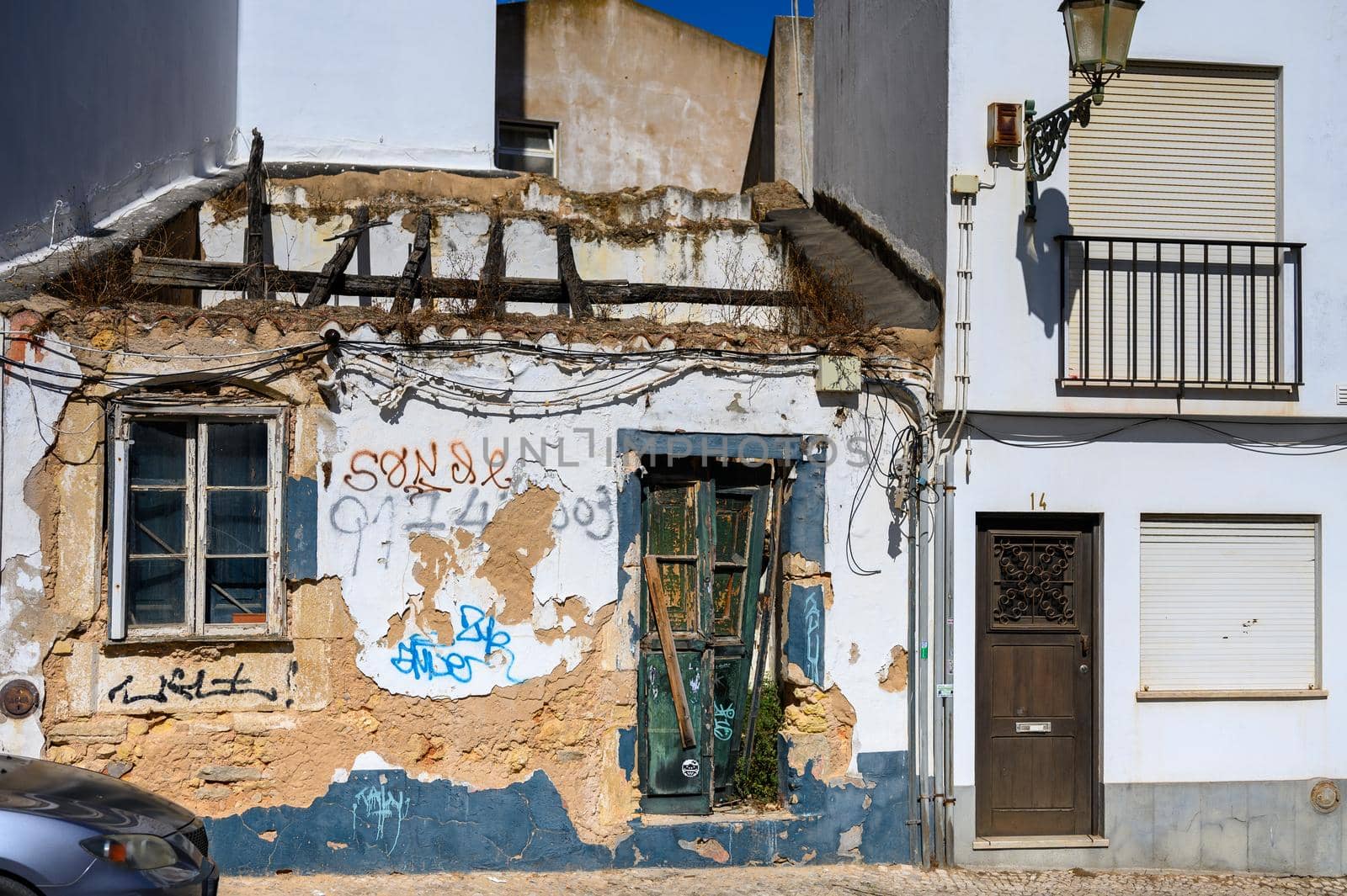 An old uninhabited house decorated with graffiti shortly before it was demolished.