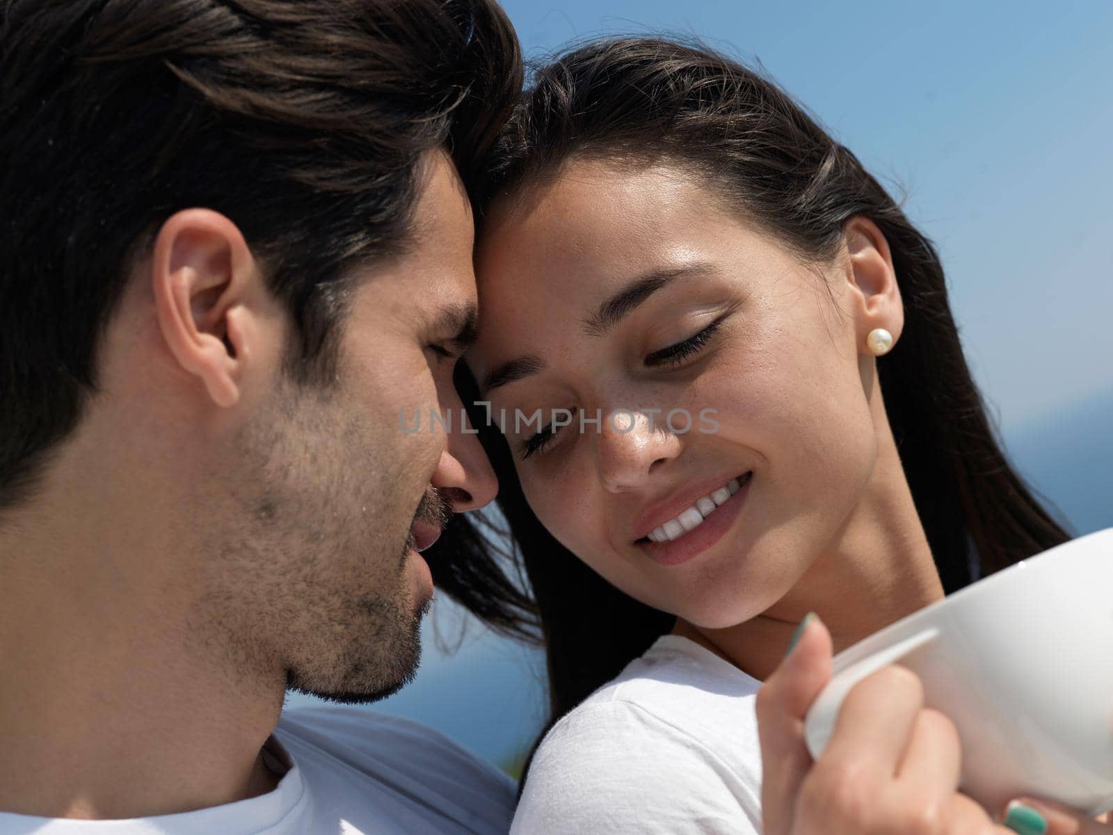 happy young romantic couple have fun relax smile at modern home outdoor terace balcony terace