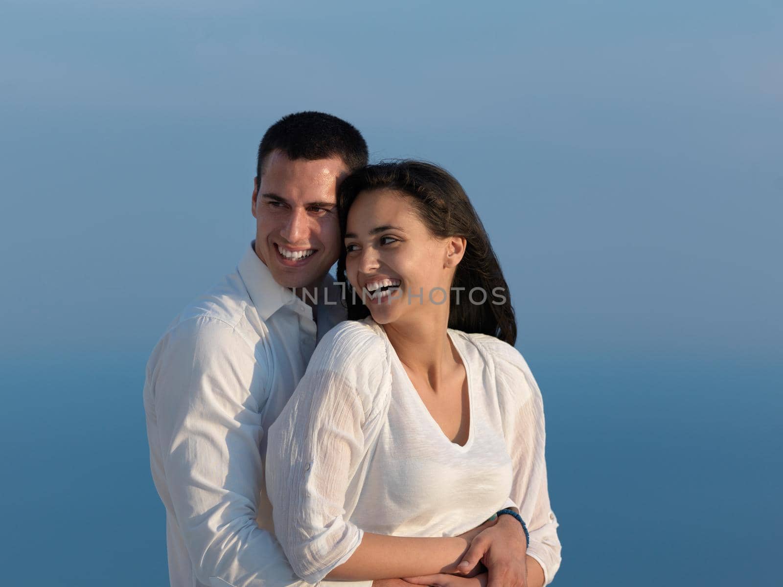 happy young romantic couple have fun relax smile at modern home outdoor terace balcony terace