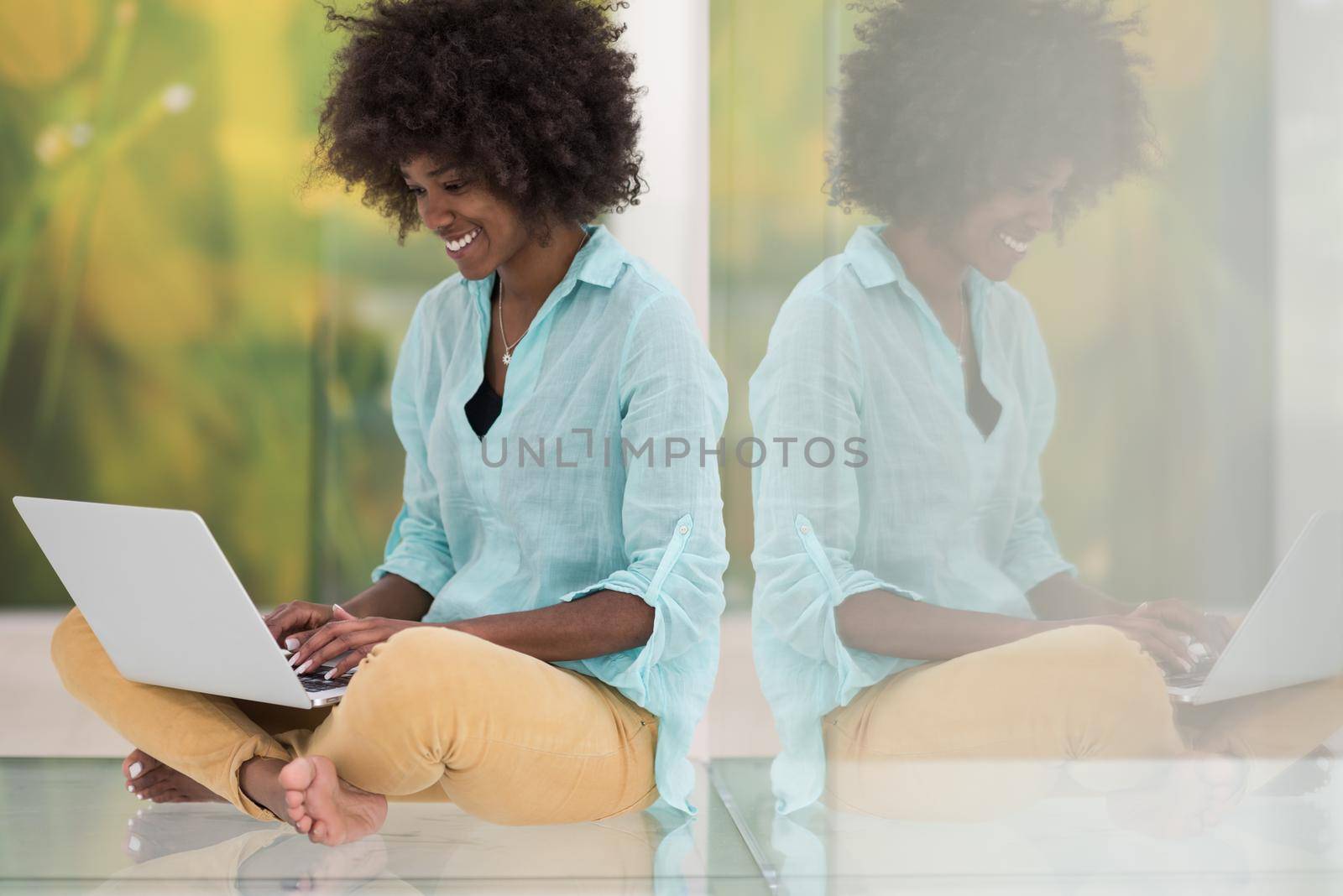 black women using laptop computer on the floor by dotshock