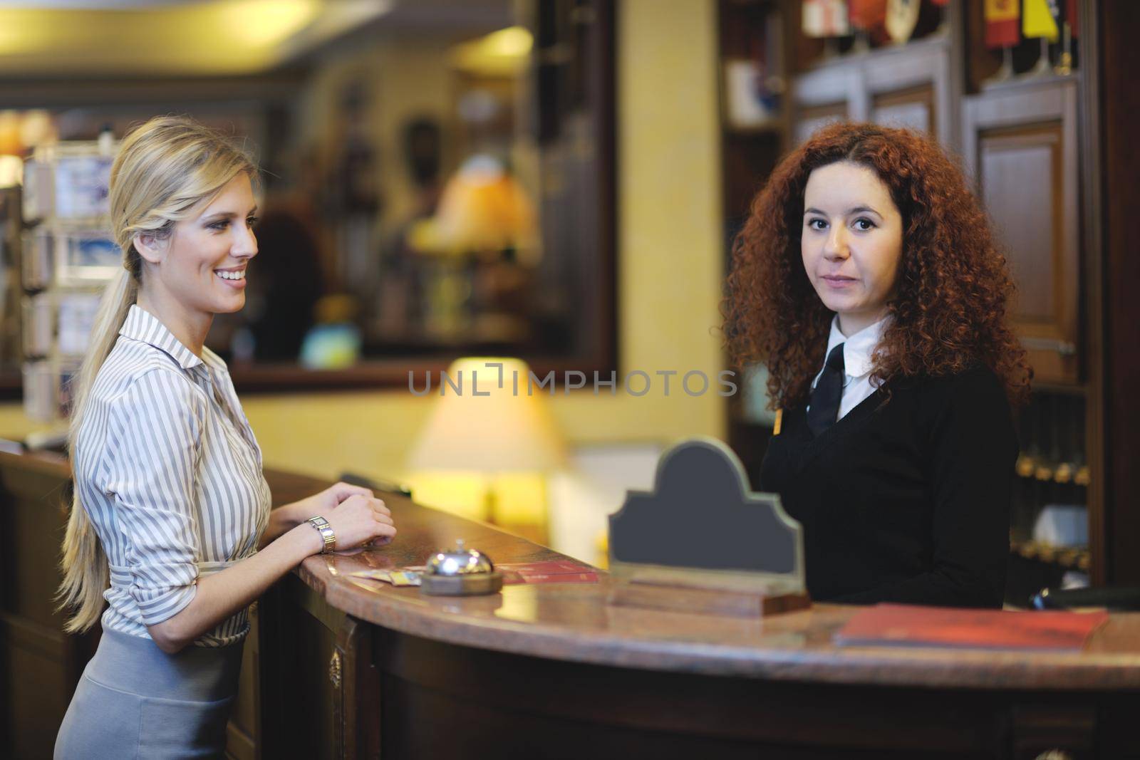 business woman  at the reception of a hotel checking in