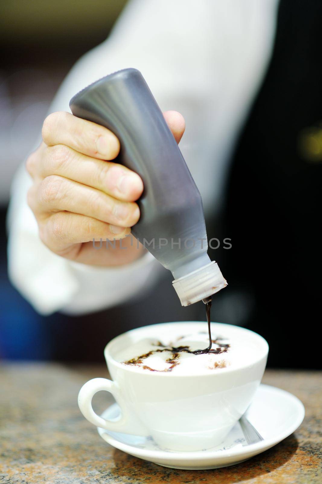 Barista prepares cappuccino by dotshock