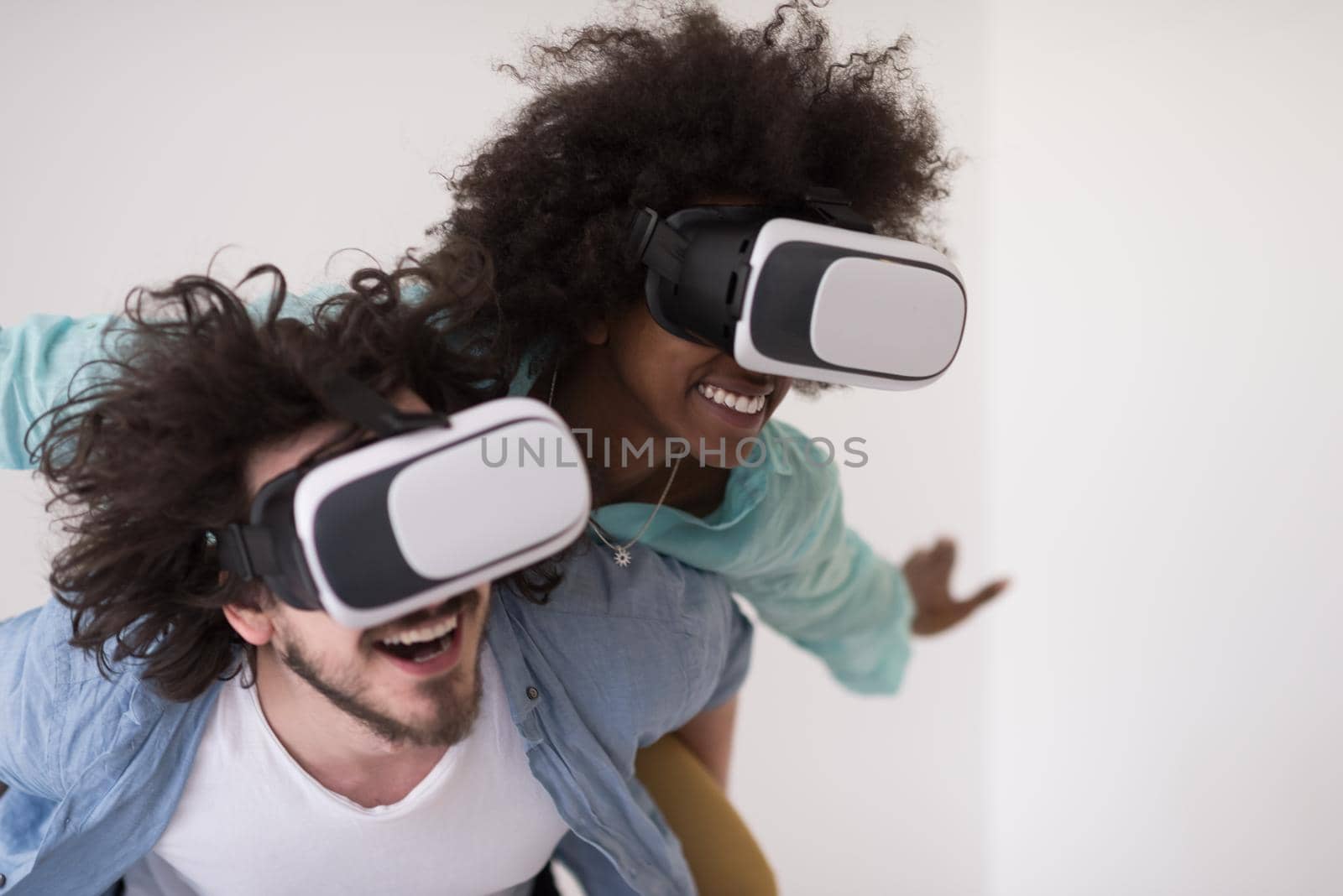 multiethnic couple getting experience using VR headset glasses by dotshock