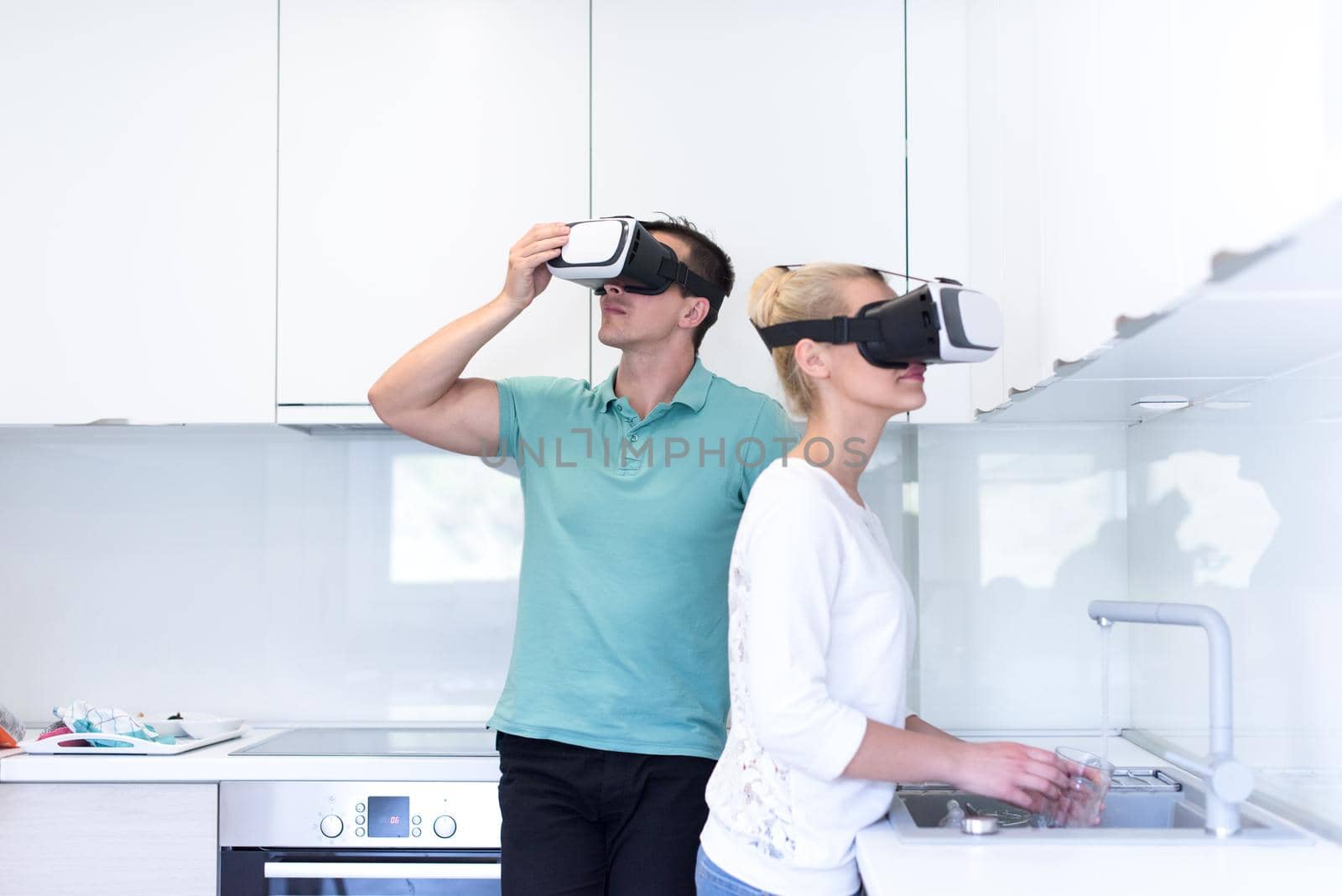 happy young couple getting experience using VR-headset glasses of virtual reality at home
