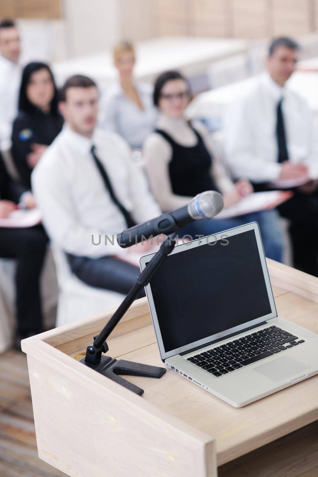 business laptop and microphotone at podium on seminar conference education